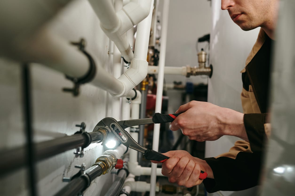 Plumbers maintaining commercial plumbing pipes in York