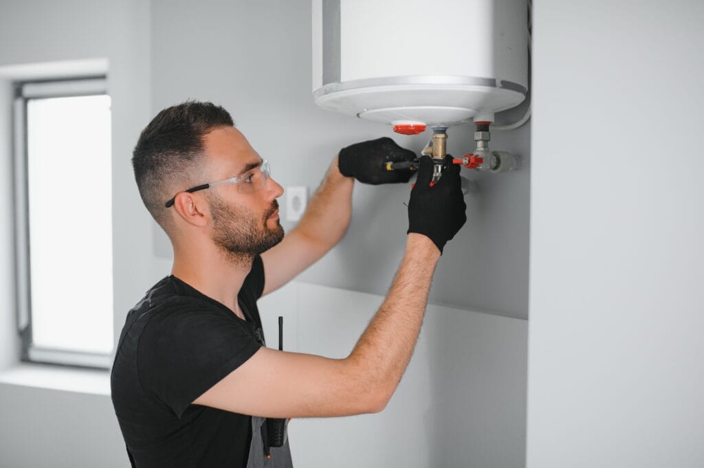 Technician performing water heater maintenance in York