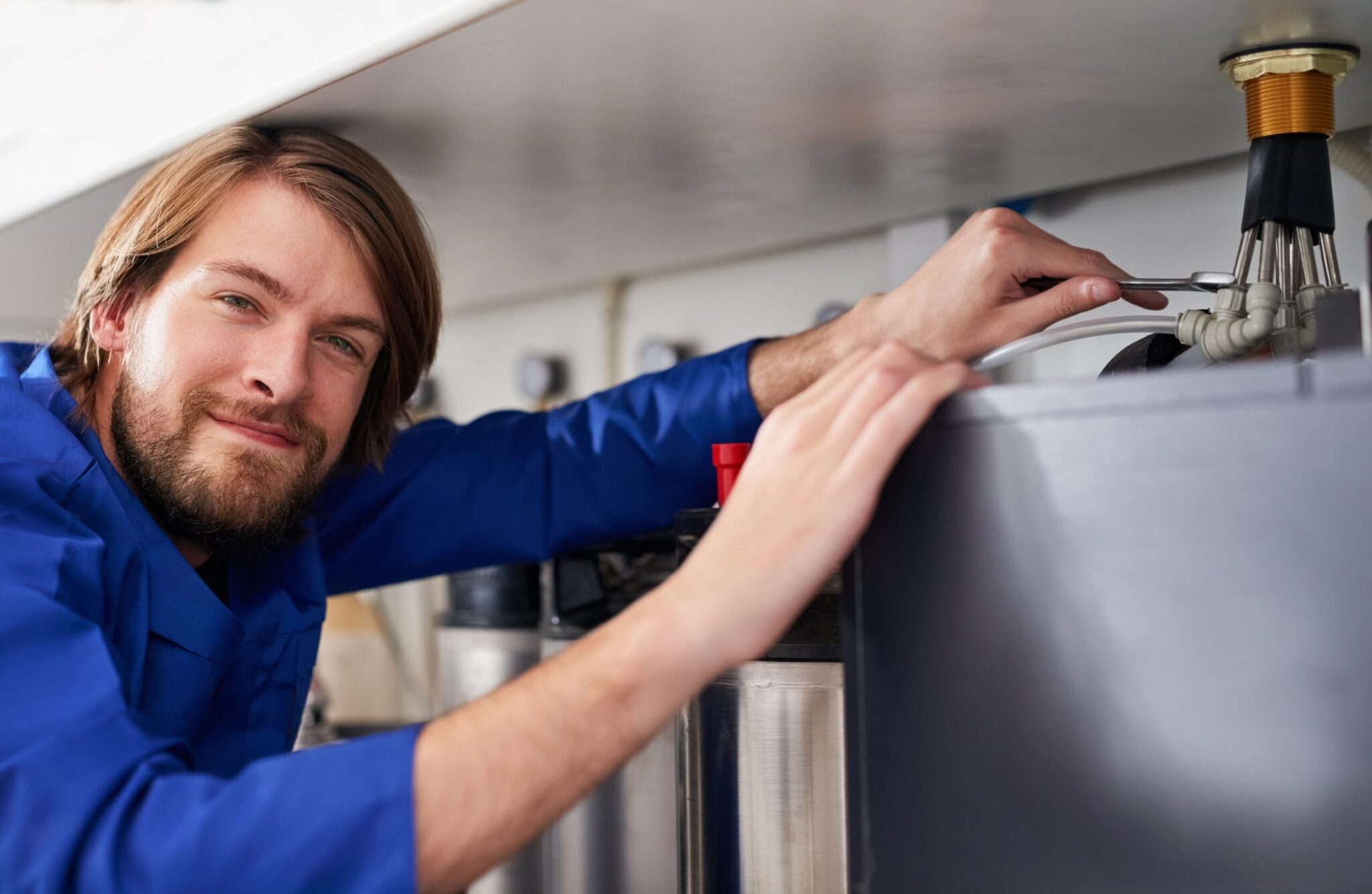 Technician servicing a residential water heater tank in York